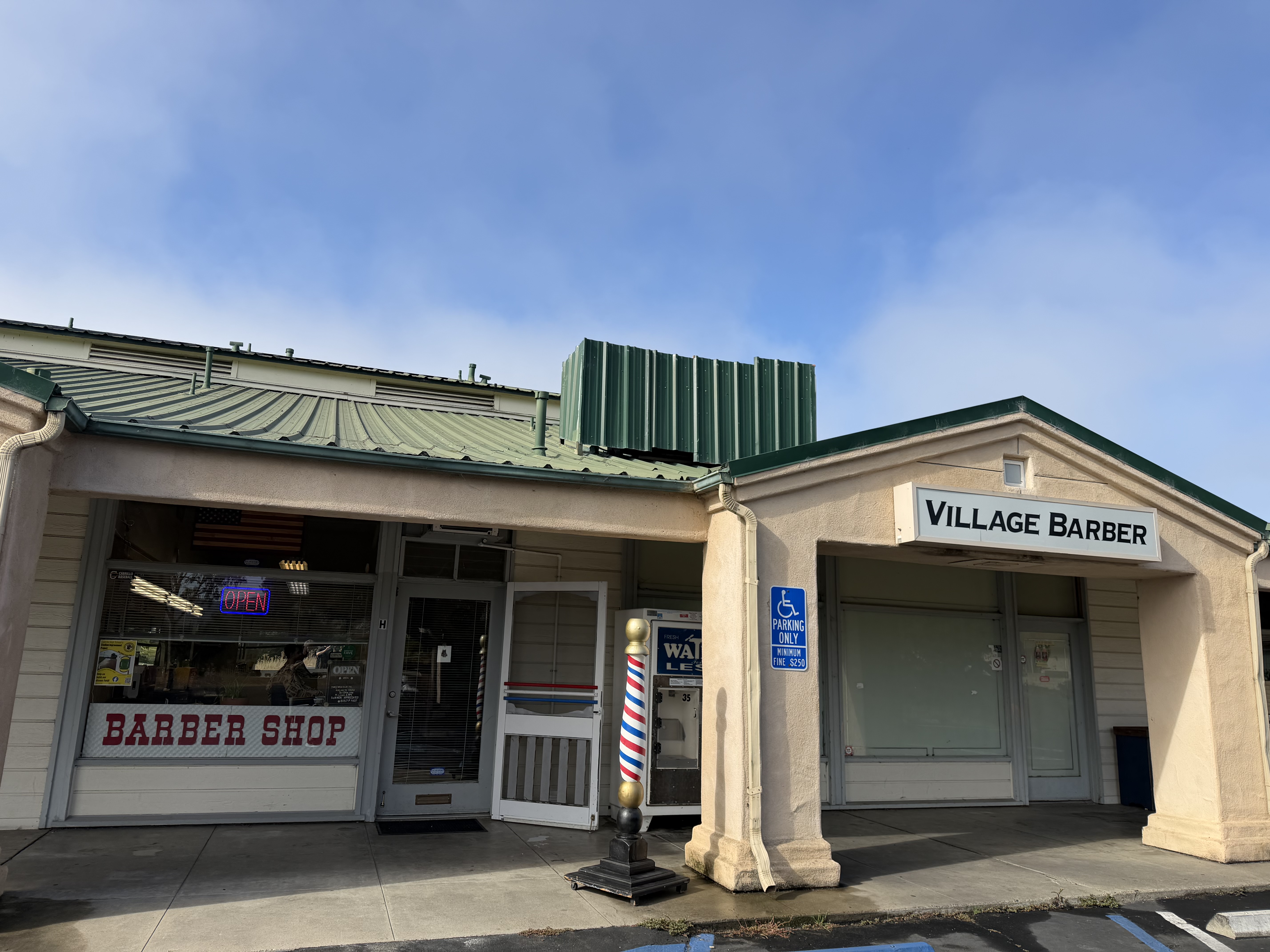 Village Barber storefront sign and barber pole