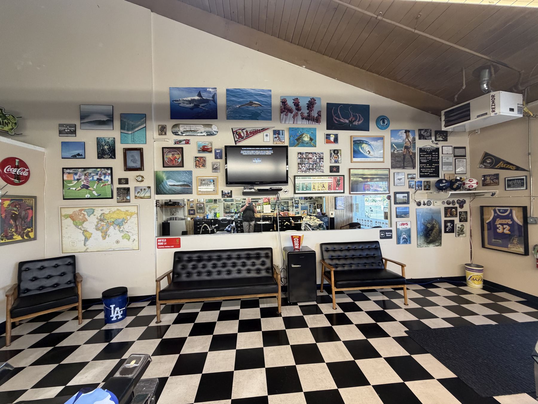 Waiting area with memorabilia wall at Village Barber Shop